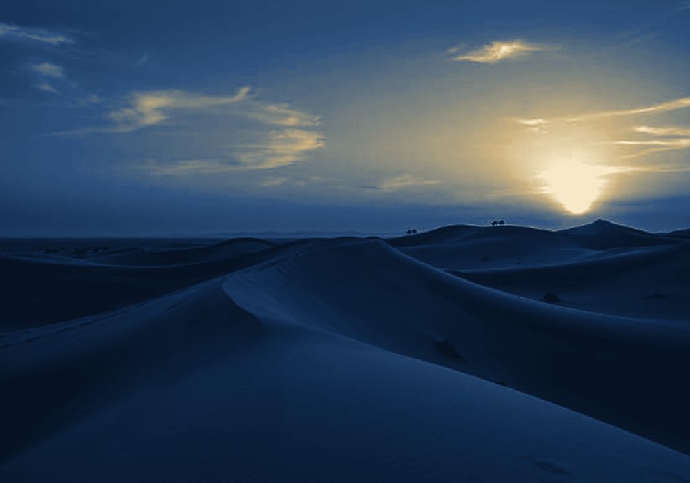 Sunrise over desert dunes